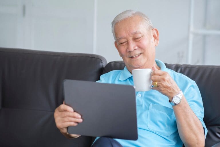 Happy senior man using online techology.